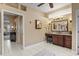 Bathroom showcasing a single sink vanity, decorative lighting, and large format tiles at 2611 Little Country Rd, Parrish, FL 34219