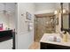 Bathroom featuring marble countertop, glass shower, and decorative towel rack at 2611 Little Country Rd, Parrish, FL 34219