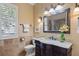 Bathroom with single sink vanity, granite counters, and a framed mirror at 2611 Little Country Rd, Parrish, FL 34219