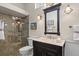 Elegant bathroom featuring tiled shower, vanity with marble countertop, and stylish decor at 2611 Little Country Rd, Parrish, FL 34219
