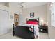 Comfortable bedroom with a black frame bed, an end table, and neutral wall color at 2611 Little Country Rd, Parrish, FL 34219