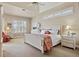 Spacious bedroom featuring a tray ceiling, neutral walls, and a large window for abundant natural light at 2611 Little Country Rd, Parrish, FL 34219
