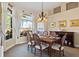 Bright dining room with large window, chandelier, and seating for six at 2611 Little Country Rd, Parrish, FL 34219