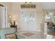 Bright foyer featuring double doors with glass panels, tile flooring, and elegant decor at 2611 Little Country Rd, Parrish, FL 34219