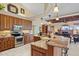 Open kitchen featuring granite countertops, stainless steel appliances, and wood cabinetry at 2611 Little Country Rd, Parrish, FL 34219