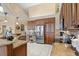 Bright kitchen with stainless steel appliances, wood cabinets, and tiled flooring at 2611 Little Country Rd, Parrish, FL 34219