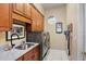 Well-lit laundry room featuring marble countertop, stainless steel washer and dryer at 2611 Little Country Rd, Parrish, FL 34219