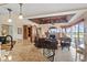 Spacious living area with a wood ceiling, fireplace, and a view of the kitchen at 2611 Little Country Rd, Parrish, FL 34219
