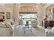Inviting living room with high ceilings, a large window, and comfortable seating overlooking the lake at 2611 Little Country Rd, Parrish, FL 34219