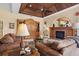 Cozy living room featuring a fireplace, built-in shelving, and comfortable seating at 2611 Little Country Rd, Parrish, FL 34219