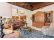 Open-concept living area with wood accents, fireplace, and connection to the kitchen at 2611 Little Country Rd, Parrish, FL 34219