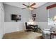 Cozy office space with a ceiling fan, a desk with chair, and a comfortable chair at 2611 Little Country Rd, Parrish, FL 34219
