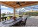 Inviting patio with a decorative dining table and views of the pool and lake at 2611 Little Country Rd, Parrish, FL 34219