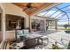 Cozy patio with a fire pit, seating area, ceiling fan, and view of the pool and lake at 2611 Little Country Rd, Parrish, FL 34219