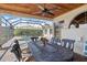 Lovely covered patio featuring a dining table, fan, and view of the pool at 2611 Little Country Rd, Parrish, FL 34219
