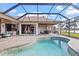 Inviting patio area with a pool, seating, and beautiful views of the lake at 2611 Little Country Rd, Parrish, FL 34219