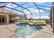 Backyard oasis featuring a pool, spa, and screened-in lanai with lake views at 2611 Little Country Rd, Parrish, FL 34219