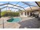 Inviting screened-in pool with brick patio and lounging area at 2611 Little Country Rd, Parrish, FL 34219