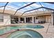 Inviting pool and spa area with a screened lanai, perfect for outdoor relaxation and entertaining at 2611 Little Country Rd, Parrish, FL 34219