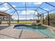 Relaxing screened-in pool and patio area with views of the lake at 2611 Little Country Rd, Parrish, FL 34219