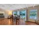 Bright dining area with wood floors and sliding glass doors that lead to the pool area at 2651 Leafy Ln, Sarasota, FL 34239