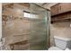 Updated bathroom shower with glass door, neutral tile, and chrome fixtures at 5343 Huntingwood Ct # 33, Sarasota, FL 34235