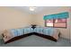 Bedroom featuring two twin beds, fan, and ample natural light at 5343 Huntingwood Ct # 33, Sarasota, FL 34235