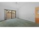 Bedroom with vaulted ceilings, green carpeting and a view to the lanai at 5343 Huntingwood Ct # 33, Sarasota, FL 34235