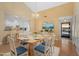 Dining room open to the kitchen with hardwood floors and a view to the front door at 5343 Huntingwood Ct # 33, Sarasota, FL 34235