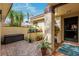 Charming brick courtyard with lush greenery, decorative plants, and inviting entrance to the home at 5343 Huntingwood Ct # 33, Sarasota, FL 34235