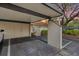 Exterior view of the covered parking, with attached storage and a gated entrance during a colorful twilight at 5343 Huntingwood Ct # 33, Sarasota, FL 34235