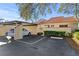 Exterior view with covered parking, tile roof, and landscaped yard at 5343 Huntingwood Ct # 33, Sarasota, FL 34235