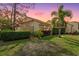 Lovely home showcasing its terracotta roof, expansive windows, lush hedges, and serene landscaping during twilight at 5343 Huntingwood Ct # 33, Sarasota, FL 34235