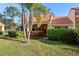 Well-maintained house featuring a tile roof, manicured lawn, and mature trees at 5343 Huntingwood Ct # 33, Sarasota, FL 34235