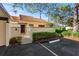 Well-maintained exterior with a tile roof, manicured landscaping, and a gated front entrance at 5343 Huntingwood Ct # 33, Sarasota, FL 34235