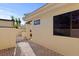 Exterior showcasing brick-paved pathway, neutral stucco, and dark window trim in this inviting home at 5343 Huntingwood Ct # 33, Sarasota, FL 34235