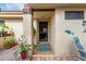 Inviting front entrance with decorative plants, brick pathway, and a charming, colorful front door at 5343 Huntingwood Ct # 33, Sarasota, FL 34235