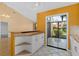 Bright kitchen with white cabinets and granite countertops with a view to the lanai and vaulted ceilings at 5343 Huntingwood Ct # 33, Sarasota, FL 34235