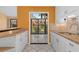 Bright kitchen with white cabinetry, granite countertops, and tile flooring with a view to the lanai at 5343 Huntingwood Ct # 33, Sarasota, FL 34235