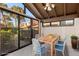 Bright lanai with tile floor, table, chairs, ceiling fan, and serene views at 5343 Huntingwood Ct # 33, Sarasota, FL 34235