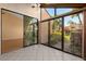 Bright lanai with tile floor and serene views at 5343 Huntingwood Ct # 33, Sarasota, FL 34235