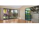 Bright living room with hardwood floors, vaulted ceilings and large windows with a view to the exterior at 5343 Huntingwood Ct # 33, Sarasota, FL 34235