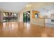 Bright living room with vaulted ceilings, hardwood floors, sliding glass doors, and an open layout to kitchen at 5343 Huntingwood Ct # 33, Sarasota, FL 34235