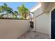 Private brick-paved patio lined with lush greenery and mature palm trees for a relaxing outdoor space at 5343 Huntingwood Ct # 33, Sarasota, FL 34235