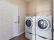 Laundry room with a white washer and dryer and a door at 6914 45Th E Ter, Bradenton, FL 34203