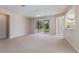 Bright and airy living room with sliding doors leading to the outdoors and a view of the kitchen at 6914 45Th E Ter, Bradenton, FL 34203