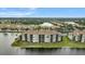 Stunning aerial view of a lakeside condo community with lush landscaping and beautiful water views at 7911 Grand Estuary Trl # 106, Bradenton, FL 34212