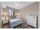 Cozy bedroom featuring a comfortable bed, bedside tables with lamps, and a dresser at 7911 Grand Estuary Trl # 106, Bradenton, FL 34212