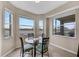 Charming breakfast nook with a glass table, four chairs, and lovely views of the surrounding landscape at 7911 Grand Estuary Trl # 106, Bradenton, FL 34212