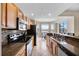 Well-equipped kitchen with modern appliances, granite countertops, and serene views from the adjacent breakfast nook at 7911 Grand Estuary Trl # 106, Bradenton, FL 34212